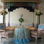 (Bride and Groom Dinner Table)
This is a wedding I set up and decorated for, as the materials were already purchased by my client. The table for 2 was set for the bride and groom with the mandap as a backdrop. White lights and tulle fabric covered the bottom of the mandap for an illuminated effect. ~