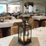 (Metal Lantern Centerpiece)
The centerpieces purchased by my client were ethnic and elegant. A flameless candle glowed within each. A gold embossed place board and blue gems completed the centerpiece. ~