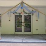 (Decorative Entrance at Temple)
The entrance to the multi purpose room was decorated with gold and blue tulle fabric, mango leaf garland and silk flowers. ~